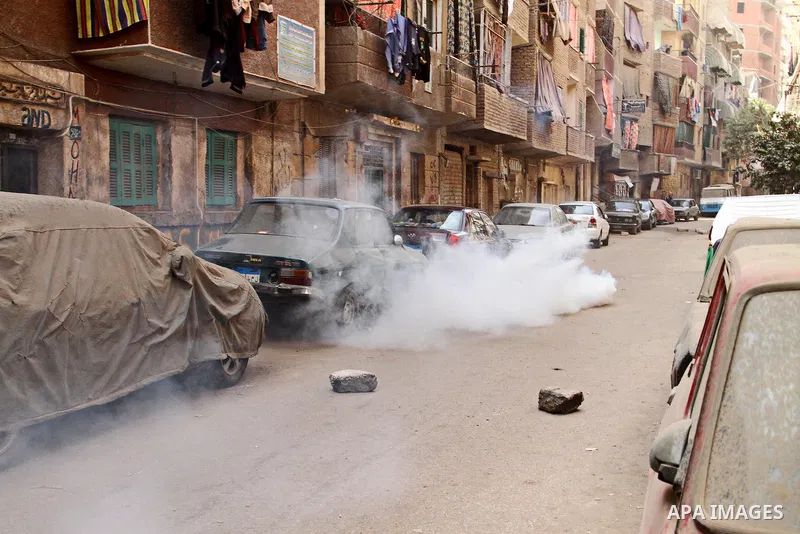 Smoke rises from a tear gas canister fired by riot police during a demonstration organised by supporters of Muslim Brotherhood and ousted President Mohammed Morsi, against military rule, in the Cairo suburb of Matariya,...