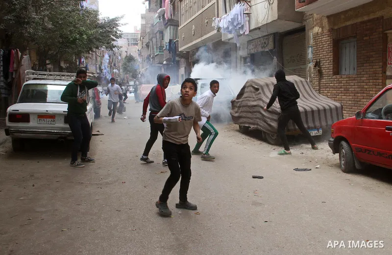 Egyptians run for cover from tear gas fired by riot police during a demonstration organised by supporters of Muslim Brotherhood and ousted President Mohammed Morsi, against military rule, in the Cairo suburb of Matariya,...