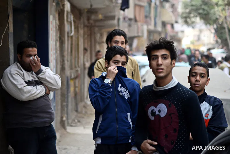 Egyptians cover their faces from tear gas fired by riot police during a demonstration organised by supporters of Muslim Brotherhood and ousted President Mohammed Morsi, against military rule, in the Cairo suburb of Matar...