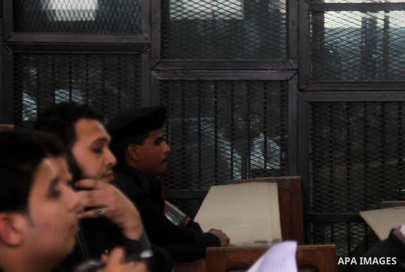 Suspects in the 'Ansar al-Sharia' case, stand in a courtroom cage during their trial in Cairo on March 14, 2015. Photo by Amr Sayed