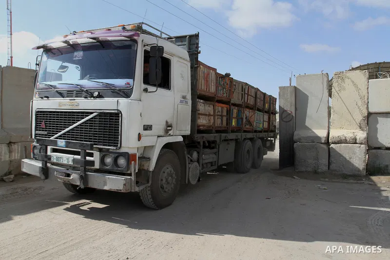 Loaded trucks cross the Kerem Shalom crossing to Rafah in southern Gaza Strip, on March 15, 2015. Gaza's agricultural sector, once a key revenue source, has for eight years been paralysed by the Israeli blockade, which c...