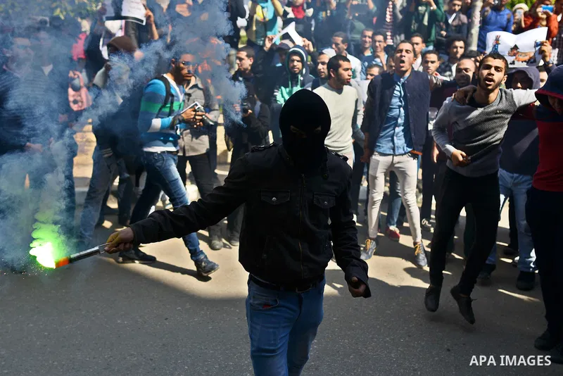 Egyptian students who support Muslim Brotherhood and ousted president Mohammed Morsi light flares during a demonstration in solidarity with the Islamic Palestinian movement of Hamas, at Cairo University on March 15, 2015...