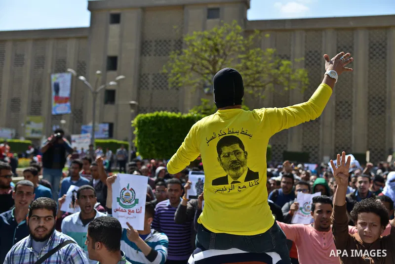 Egyptian students who support Muslim Brotherhood and ousted president Mohammed Morsi, shout slogans during a demonstration in solidarity with the Islamic Palestinian movement of Hamas, at Cairo University on March 15, 20...