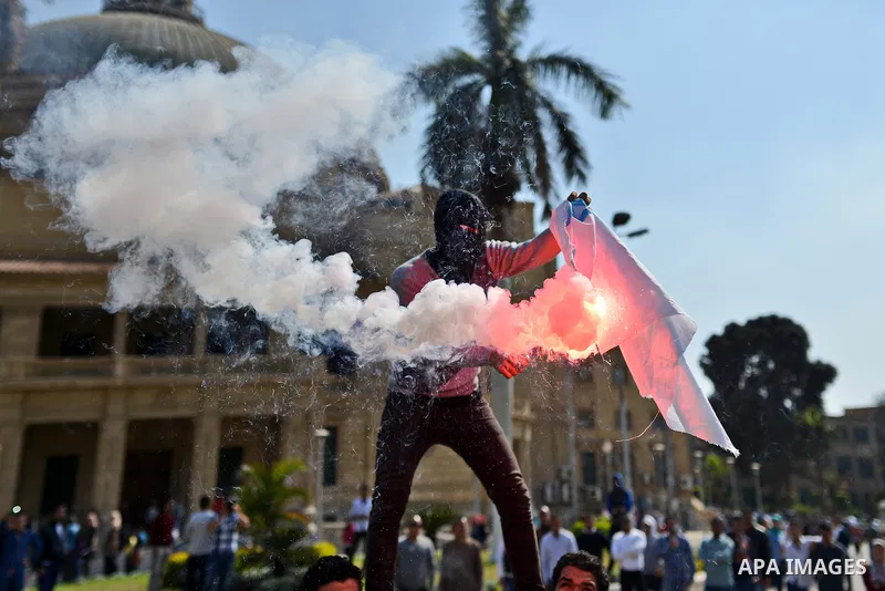 Egyptian students who support Muslim Brotherhood and ousted president Mohammed Morsi burn the Israeli flag during a demonstration in solidarity with the Islamic Palestinian movement of Hamas, at Cairo University on March...