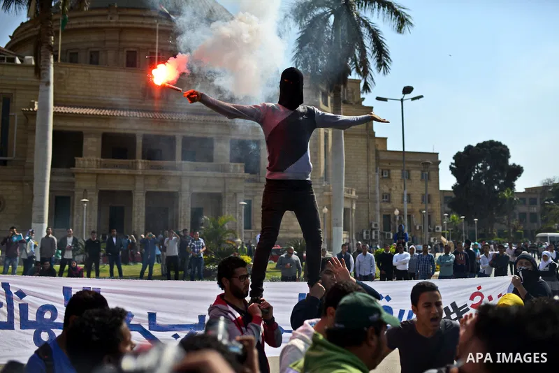 Egyptian students who support Muslim Brotherhood and ousted president Mohammed Morsi light flares during a demonstration in solidarity with the Islamic Palestinian movement of Hamas, at Cairo University on March 15, 2015...