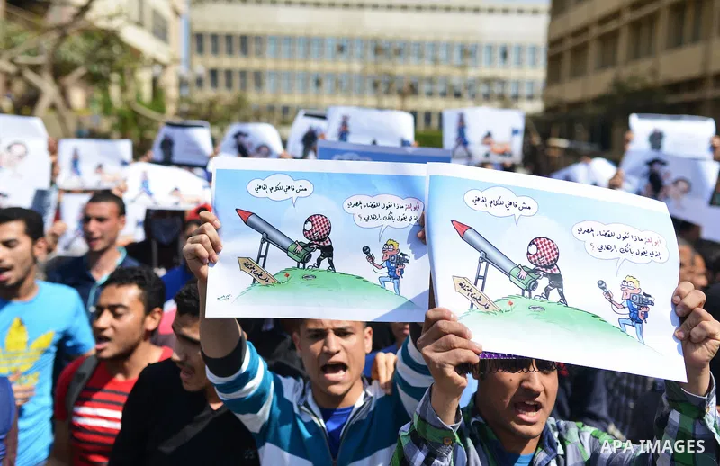 Egyptian students who support Muslim Brotherhood and ousted president Mohammed Morsi hold banners during a demonstration in solidarity with the Islamic Palestinian movement of Hamas, at Cairo University on March 15, 2015...