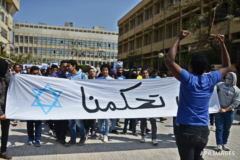 Egyptian students who support Muslim Brotherhood and ousted president Mohammed Morsi hold banners during a demonstration in solidarity with the Islamic Palestinian movement of Hamas, at Cairo University on March 15, 2015...