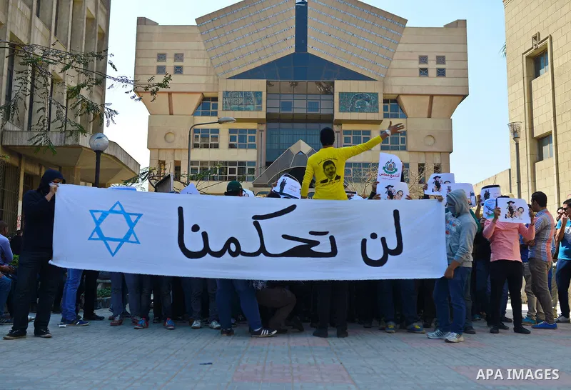 Egyptian students who support Muslim Brotherhood and ousted president Mohammed Morsi hold banners during a demonstration in solidarity with the Islamic Palestinian movement of Hamas, at Cairo University on March 15, 2015...