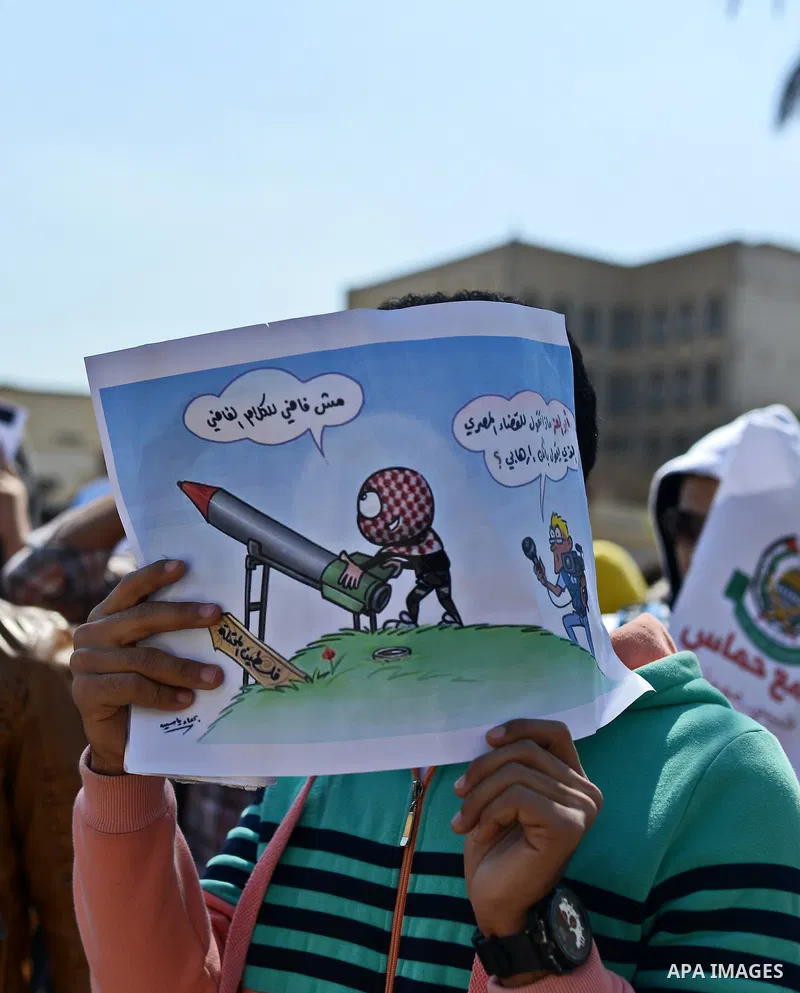 Egyptian students who support Muslim Brotherhood and ousted president Mohammed Morsi hold banners during a demonstration in solidarity with the Islamic Palestinian movement of Hamas, at Cairo University on March 15, 2015...