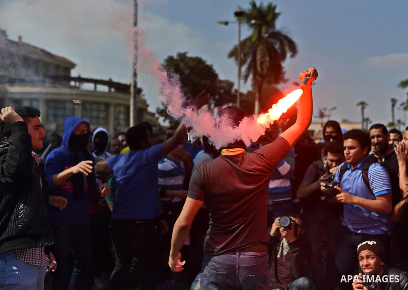 Egyptian students who support Muslim Brotherhood and ousted president Mohammed Morsi light flares during a demonstration in solidarity with the Islamic Palestinian movement of Hamas, at Cairo University on March 15, 2015...