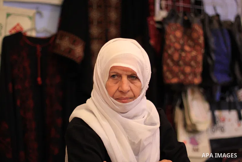 Palestinians participate in the opening of an exhibition of Palestinian heritage entitled "products of our women", in Gaza City, on March 16, 2015. Photo by Mohammed Asad