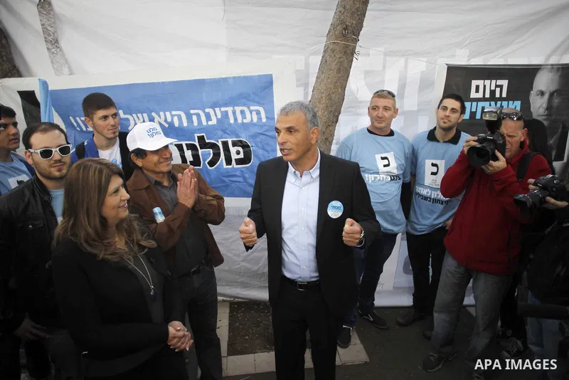 Israel's Kulanu leader Moshe Kahlon casts his ballot at a polling station during the parliamentary election in Haifa, northernn Israel, on March 17, 2015. Millions of Israelis voted on Tuesday in a tightly fought electio...