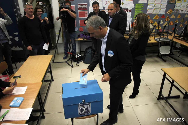 Israel's Kulanu leader Moshe Kahlon casts his ballot at a polling station during the parliamentary election in Haifa, northernn Israel, on March 17, 2015. Millions of Israelis voted on Tuesday in a tightly fought electio...