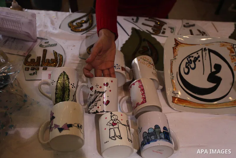Palestinians participate in the opening of an exhibition of Palestinian heritage entitled "products of our women", in Gaza City, on March 18, 2015. Photo by Ashraf Amra