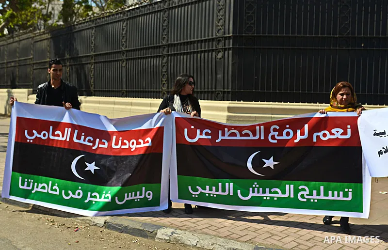 Egyptians hold Libyan flags during a rally to support the Egyptian army and President Abdel Fattah al-Sisi, outside the Arab League headquarters, in Cairo on March 18, 2015. Photo by Amr Sayed