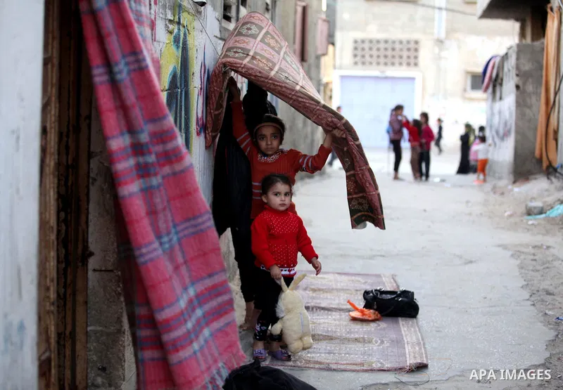 Palestinian children play outside their family's home in al-Shatie refugee camp, in Gaza city on March 18, 2015. Israel's Prime Minister Benjamin Netanyahu won a come-from-behind victory in Israel's election after tackin...