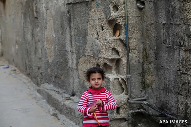 A Palestinian girl plays outside her family's home in al-Shatie refugee camp, in Gaza city on March 18, 2015. Israel's Prime Minister Benjamin Netanyahu won a come-from-behind victory in Israel's election after tacking h...