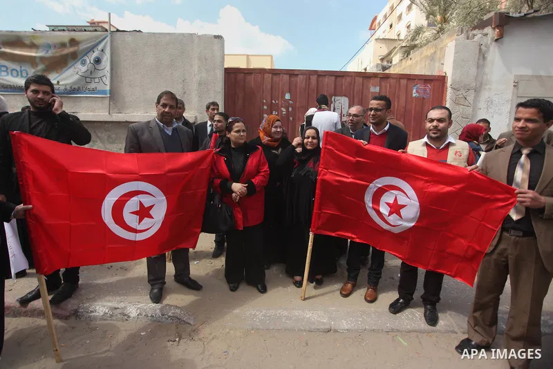 Palestinian take part in a protest to show solidarity with Tunisia after the terrorist attack at the Bardo Museum which caused 22 dead and 50 wounded among the tourists, in front of the Tunisian community, in Gaza city,...