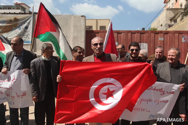 Palestinian take part in a protest to show solidarity with Tunisia after the terrorist attack at the Bardo Museum which caused 22 dead and 50 wounded among the tourists, in front of the Tunisian community, in Gaza city,...