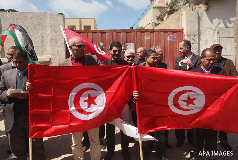 Palestinian take part in a protest to show solidarity with Tunisia after the terrorist attack at the Bardo Museum which caused 22 dead and 50 wounded among the tourists, in front of the Tunisian community, in Gaza city,...