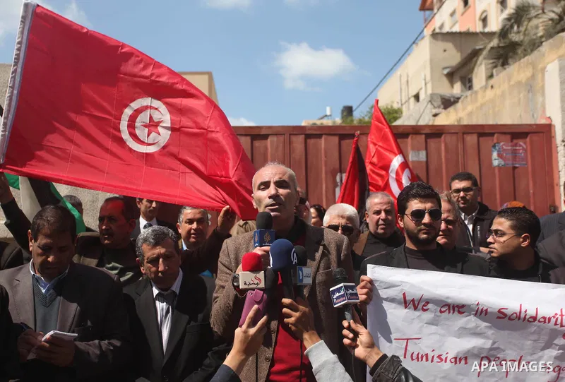 Palestinian take part in a protest to show solidarity with Tunisia after the terrorist attack at the Bardo Museum which caused 22 dead and 50 wounded among the tourists, in front of the Tunisian community, in Gaza city,...