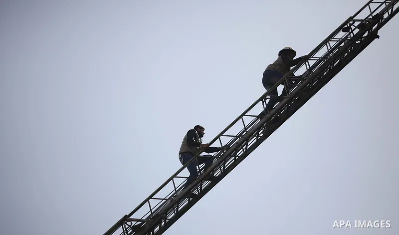 Palestinian Civil Defense members and students take part in a drill at a scene simulating a fire at University College of Applied Sciences by an Israeli air strike, in Gaza city March 24, 2015. Photo by Ashraf Amra