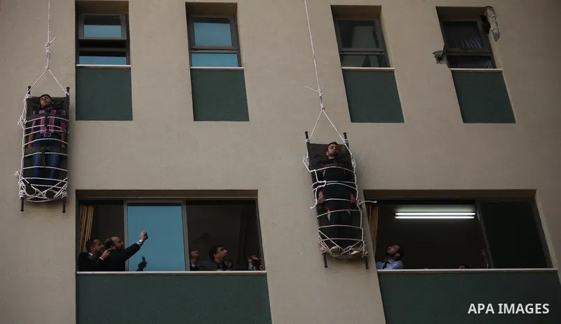 Palestinian Civil Defense members and students take part in a drill at a scene simulating a fire at University College of Applied Sciences by an Israeli air strike, in Gaza city March 24, 2015. Photo by Ashraf Amra