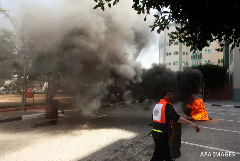 Palestinian Civil Defense members and students take part in a drill at a scene simulating a fire at University College of Applied Sciences by an Israeli air strike, in Gaza city March 24, 2015. Photo by Ashraf Amra