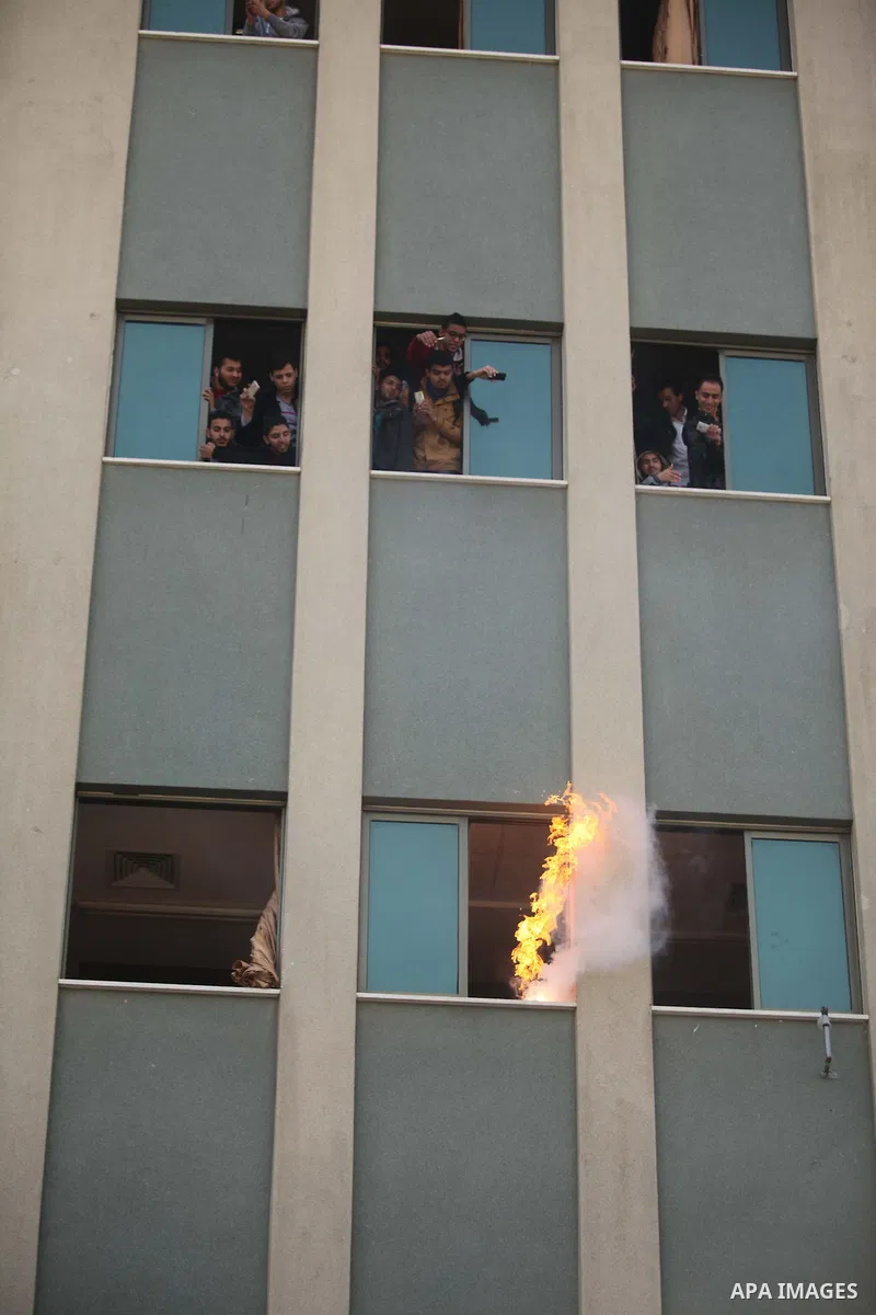 Palestinian Civil Defense members and students take part in a drill at a scene simulating a fire at University College of Applied Sciences by an Israeli air strike, in Gaza city March 24, 2015. Photo by Ashraf Amra