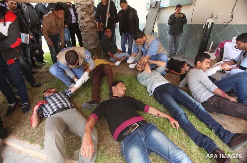 Palestinian Civil Defense members and students take part in a drill at a scene simulating a fire at University College of Applied Sciences by an Israeli air strike, in Gaza city March 24, 2015. Photo by Ashraf Amra