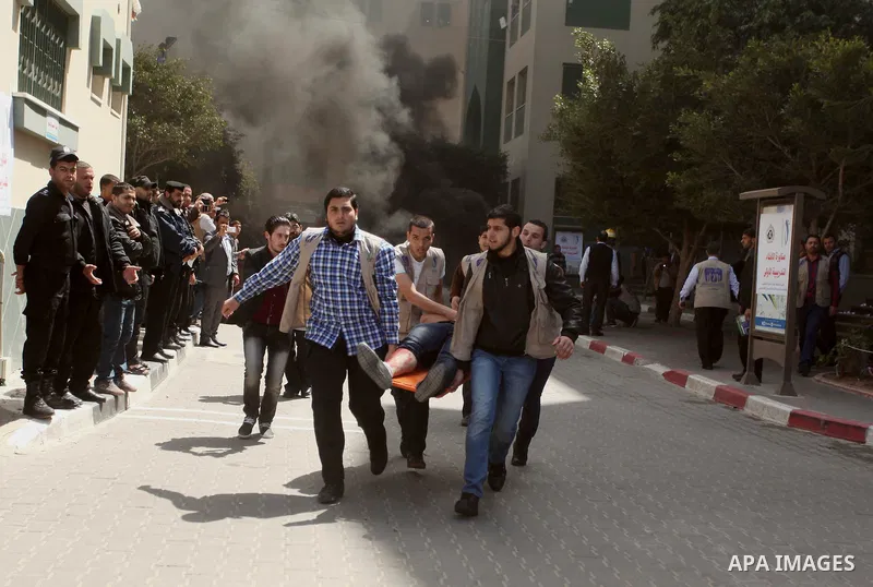 Palestinian Civil Defense members and students take part in a drill at a scene simulating a fire at University College of Applied Sciences by an Israeli air strike, in Gaza city March 24, 2015. Photo by Ashraf Amra