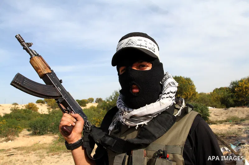 A masked Palestinian militant of al-Aqsa Martyrs' Brigades, a group linked to the Fatah movement, demonstrates his skills during a training in Rafah, southern Gaza Strip, on March 25, 2015. Photo by Abed Rahim Khatib