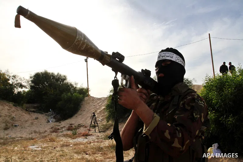 A masked Palestinian militant of al-Aqsa Martyrs' Brigades, a group linked to the Fatah movement, demonstrates his skills during a training in Rafah, southern Gaza Strip, on March 25, 2015. Photo by Abed Rahim Khatib