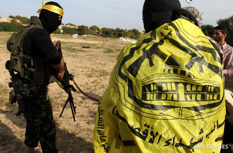 Masked Palestinian militants of al-Aqsa Martyrs' Brigades, a group linked to the Fatah movement, demonstrate their skills during a training in Rafah, southern Gaza Strip, on March 25, 2015. Photo by Abed Rahim Khatib
