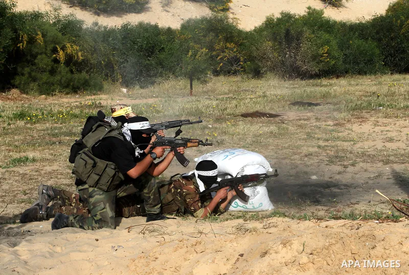 Masked Palestinian militants of al-Aqsa Martyrs' Brigades, a group linked to the Fatah movement, demonstrate their skills during a training in Rafah, southern Gaza Strip, on March 25, 2015. Photo by Abed Rahim Khatib