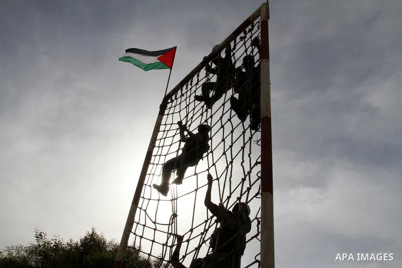 Masked Palestinian militants of al-Aqsa Martyrs' Brigades, a group linked to the Fatah movement, demonstrate their skills during a training in Rafah, southern Gaza Strip, on March 25, 2015. Photo by Abed Rahim Khatib