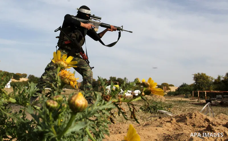 A masked Palestinian militant of al-Aqsa Martyrs' Brigades, a group linked to the Fatah movement, demonstrates his skills during a training in Rafah, southern Gaza Strip, on March 25, 2015. Photo by Abed Rahim Khatib