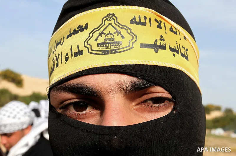Masked Palestinian militants of al-Aqsa Martyrs' Brigades, a group linked to the Fatah movement, poses during a training in Rafah, southern Gaza Strip, on March 25, 2015. Photo by Abed Rahim Khatib