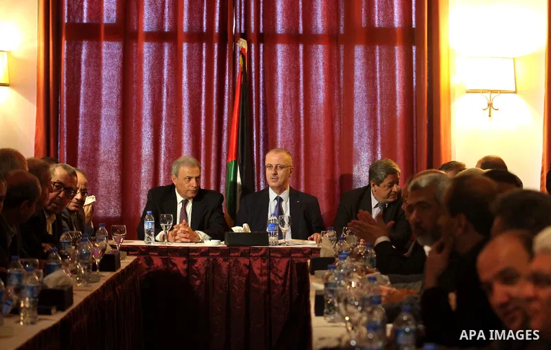 Palestinian prime minister Rami Hamdallah attends a meeting with Palestinian factions and parties in Gaza Strip, in Gaza city on March 26, 2015. Hamdallah urged rival factions to set aside their differences, even as prot...