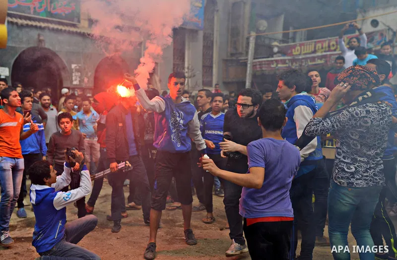 Egyptian supporters of Muslim Brotherhood and ousted president Mohammed Morsi light flares during a demonstration against military rule in al-Matariya district, in Cairo on March 27, 2015. Photo by Amr Sayed