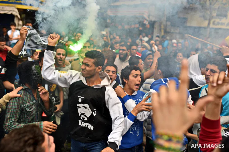 Egyptian supporters of Muslim Brotherhood and ousted president Mohammed Morsi light flares during a demonstration against military rule in al-Matariya district, in Cairo on March 27, 2015. Photo by Amr Sayed