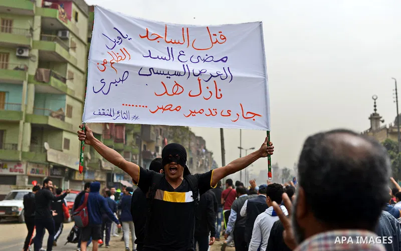 An Egyptian supporter of Muslim Brotherhood and ousted president Mohammed Morsi holds banner during a demonstration against military rule in al-Matariya district, in Cairo on March 27, 2015. Photo by Amr Sayed