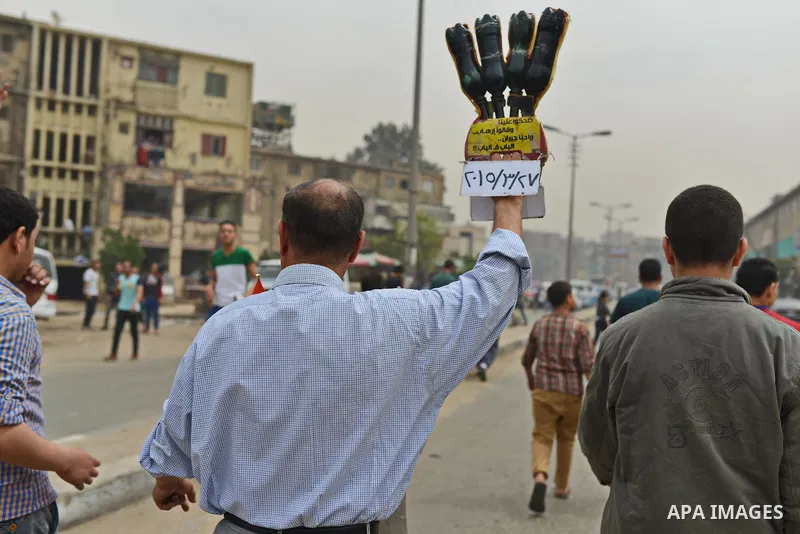 An Egyptian supporter of Muslim Brotherhood and ousted president Mohammed Morsi flashes Eabaa sign during a demonstration against military rule in al-Matariya district, in Cairo on March 27, 2015. Photo by Amr Sayed