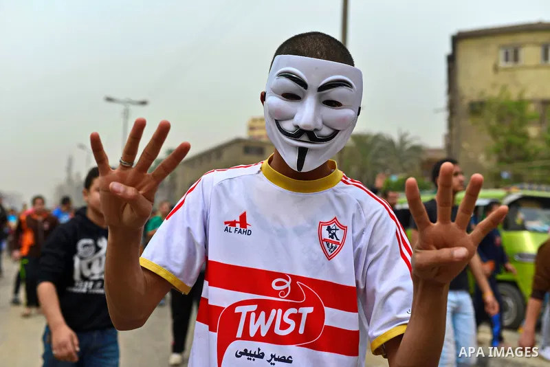 An Egyptian supporter of Muslim Brotherhood and ousted president Mohammed Morsi flashes Eabaa sign during a demonstration against military rule in al-Matariya district, in Cairo on March 27, 2015. Photo by Amr Sayed