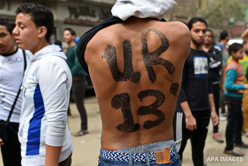 An Egyptian supporter of Muslim Brotherhood and ousted president Mohammed Morsi shows his back during a demonstration against military rule in al-Matariya district, in Cairo on March 27, 2015. Photo by Amr Sayed