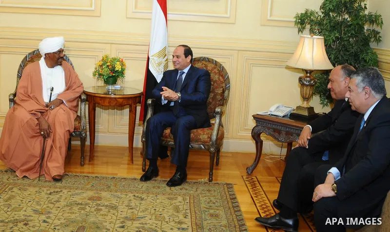 A handout picture made available by the Egyptian presidency shows Egyptian President Abdel Fattah al-Sisi (C-R) walking alongside Sudanese President Omar al-Bashir upon the latter's arrival in Red Sea resort of Sharm El-...