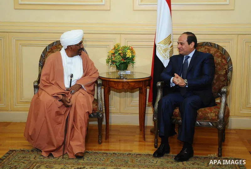 A handout picture made available by the Egyptian presidency shows Egyptian President Abdel Fattah al-Sisi (C-R) walking alongside Sudanese President Omar al-Bashir upon the latter's arrival in Red Sea resort of Sharm El-...