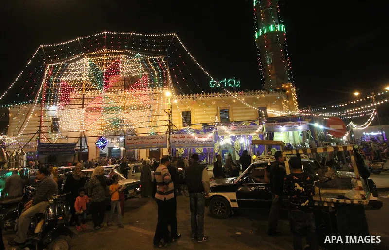 Egyptian worshippers attend a Mawlid Nafisa, a religious celebration marking the birthday of the granddaughter of the Prophet Muhammad, in Cairo, Egypt, on March 27, 2015. Photo by Amr Sayed
