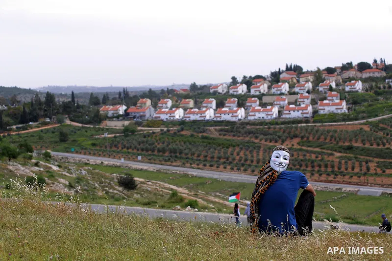 A Palestinian protester looks on during a protest marking the Palestinian Land Day in the West Bank village of Nabi Saleh near Ramallah, March 28, 2015. Land Day commemorates the unrest that erupted in March 1976 when Is...