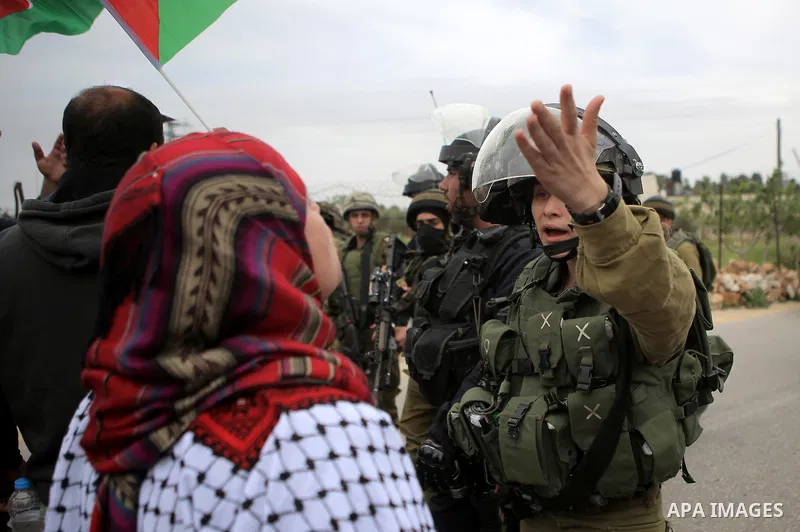 A Palestinian woman argues with a member of Israeli security forces during a protest marking the Palestinian Land Day in the West Bank village of Nabi Saleh near Ramallah, March 28, 2015. Land Day commemorates the unrest...